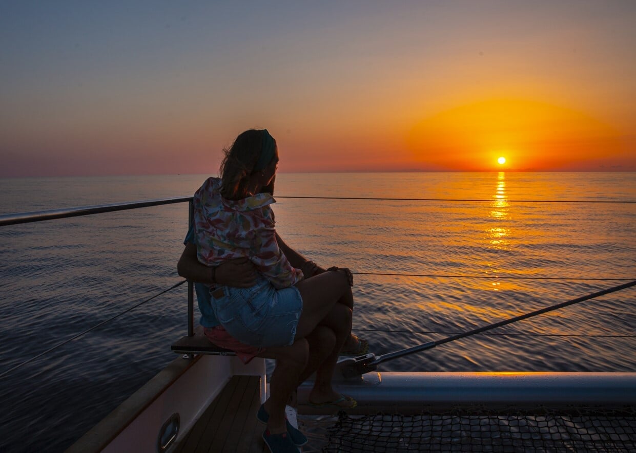 Frau im Sonnenaufgang auf dem Boot